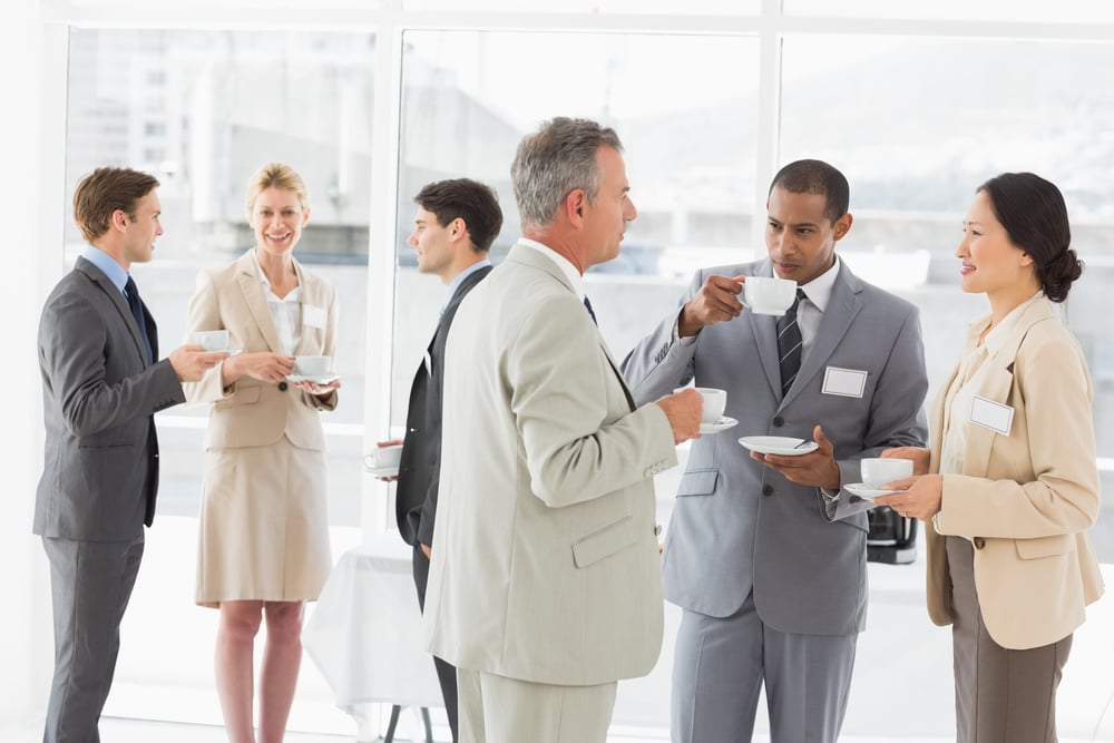 Business people chatting and drinking coffee at a conference in the office